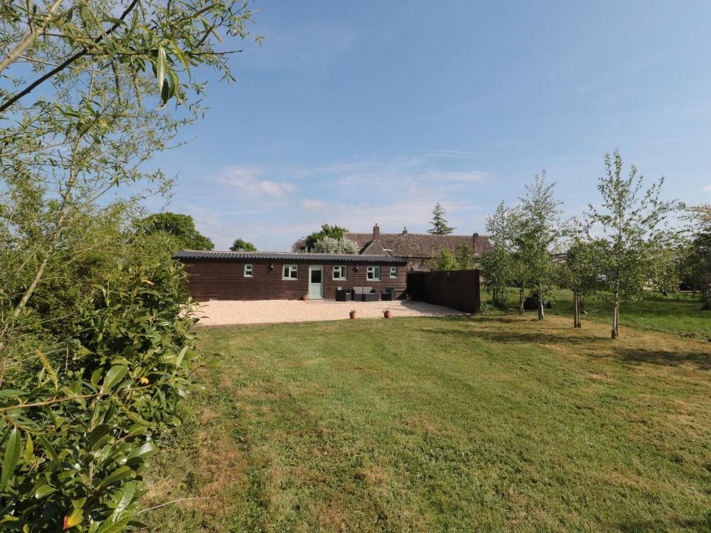 a house with a large yard in front of it at Garden Cottage, Rode Farm in Frome