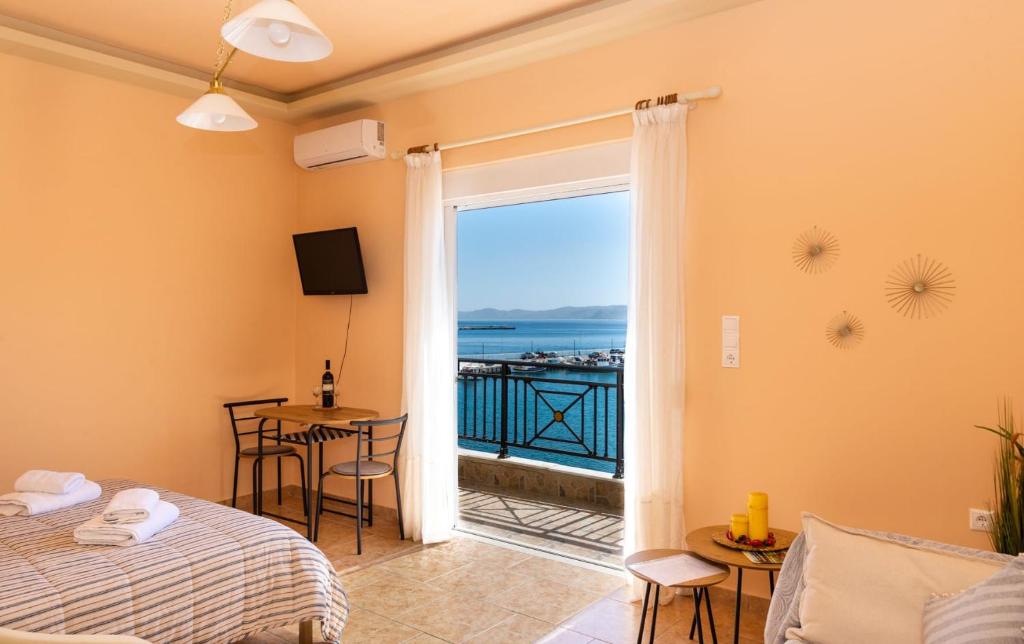 a room with a bed and a view of the ocean at Sitia Old Port studio - 3min walk to beach - AC - WIFI in Sitia