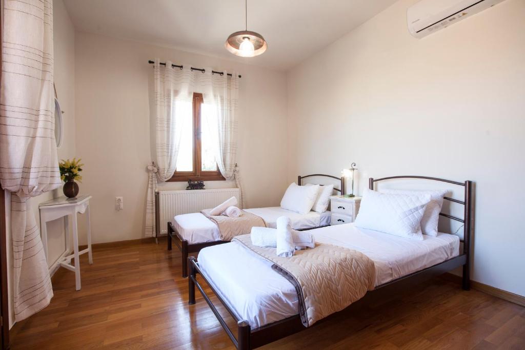 Postel nebo postele na pokoji v ubytování Villa Greco