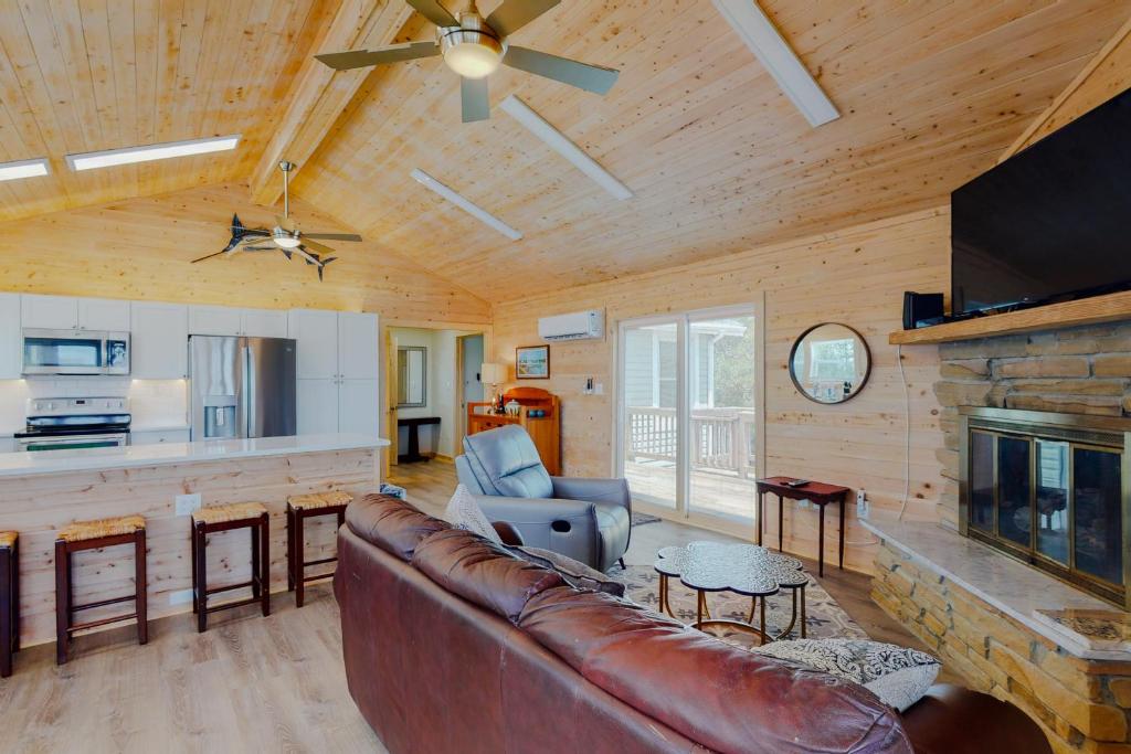 a living room with a couch and a fireplace at Bikini Bottom NH118 in Nags Head