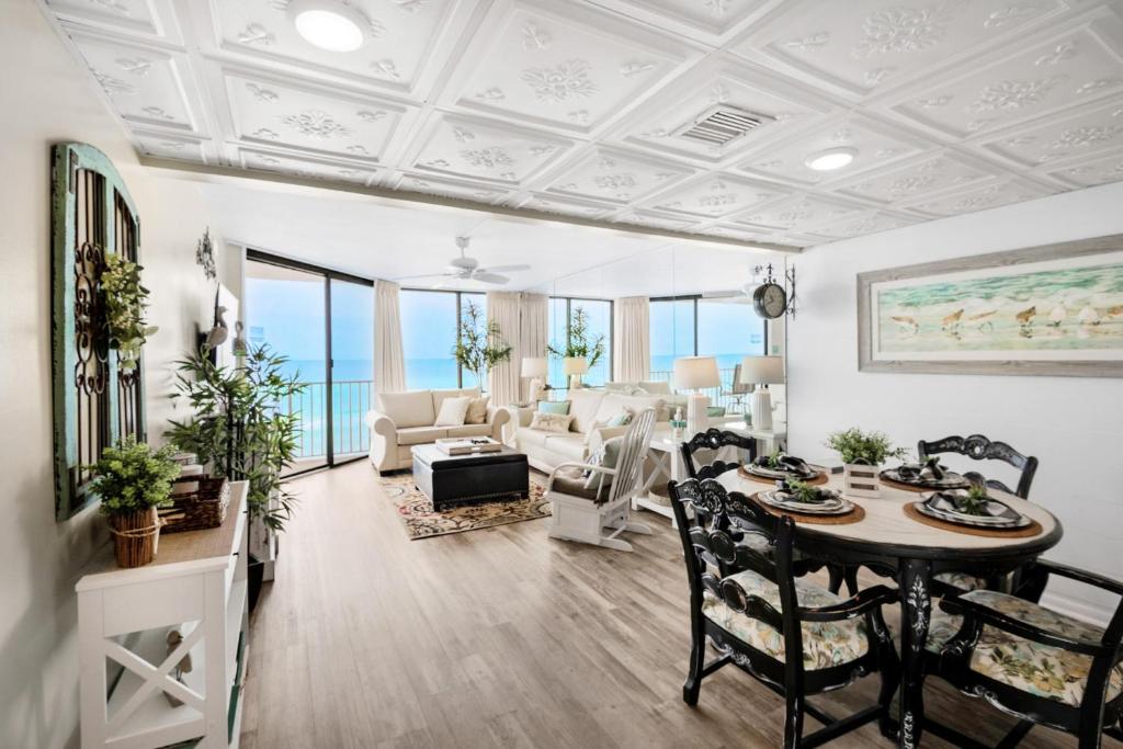 a living room with a table and chairs at Windward 403 at Edgewater in Panama City Beach