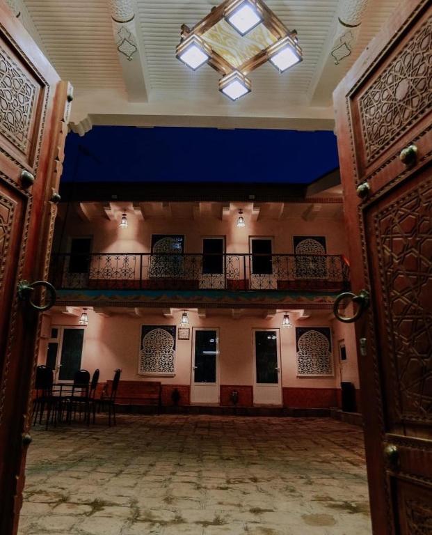 an open door to a large room with a balcony at Bukhara house hotel in Bukhara