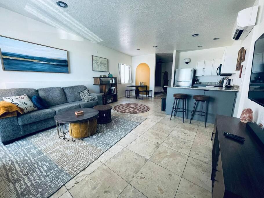 a living room with a couch and a kitchen at Pet Friendly! Private retreat in Nob Hill in Albuquerque