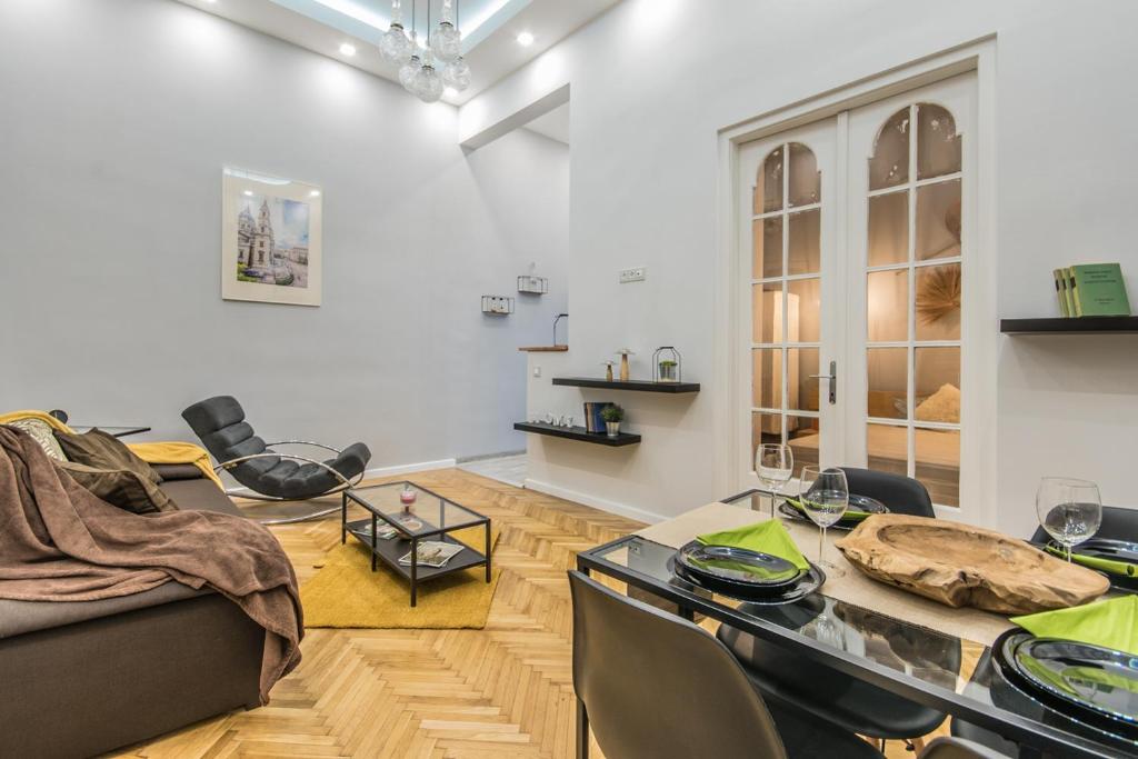 a living room with a couch and a table at SemmiHome Budapest Semmelweis Street in Budapest