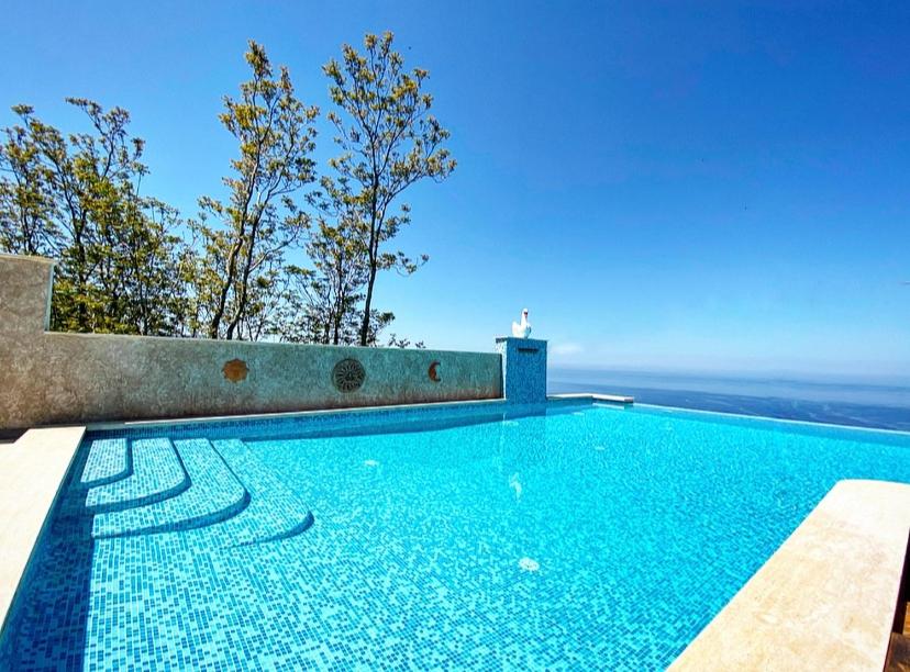 a swimming pool with a view of the ocean at Resort - Località Santa Barbara in Bagnara Calabra