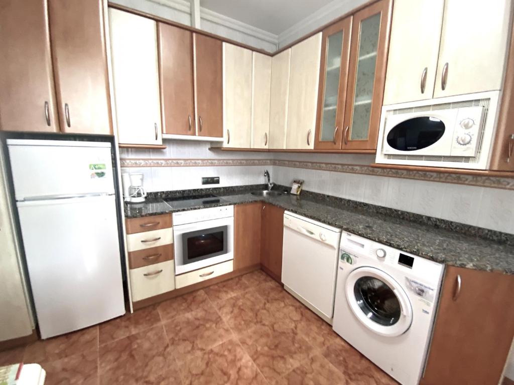 A kitchen or kitchenette at Apartamentos Pineda