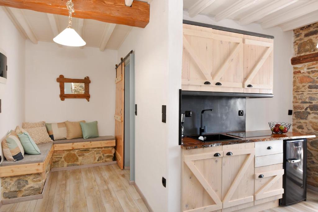 a kitchen with wooden cabinets and a sliding barn door at Tramuntana in Ano Syros
