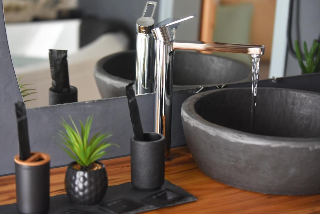 a bathroom sink with a water faucet and a sink at Tramuntana in Ano Syros
