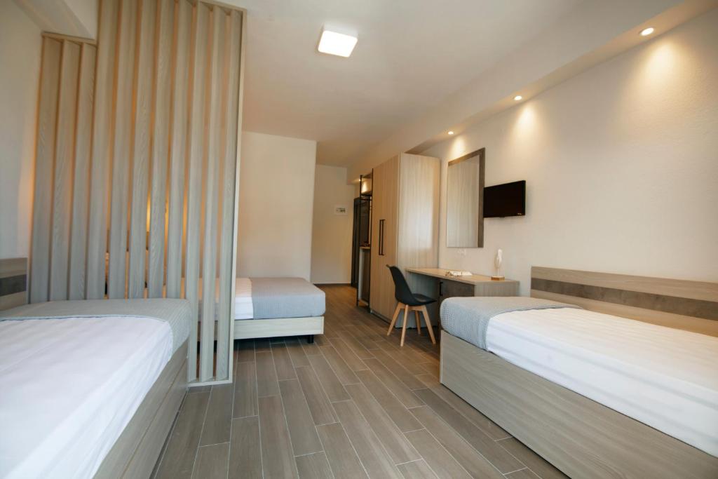 Postel nebo postele na pokoji v ubytování Akti Liakada Hotel