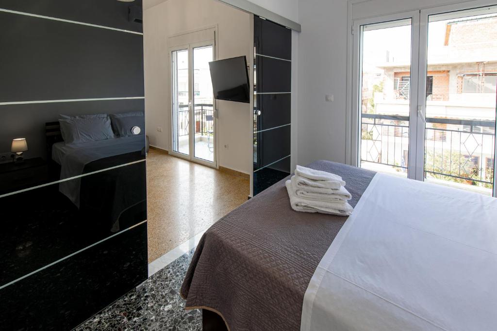a bedroom with a bed with towels on it at Fantastic location who love sea and center in Athens