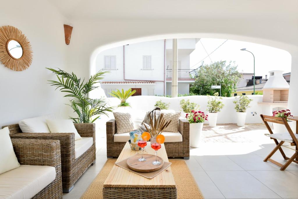 a living room with couches and a table at casa vacanze La Dolce sosta in Lotzorai