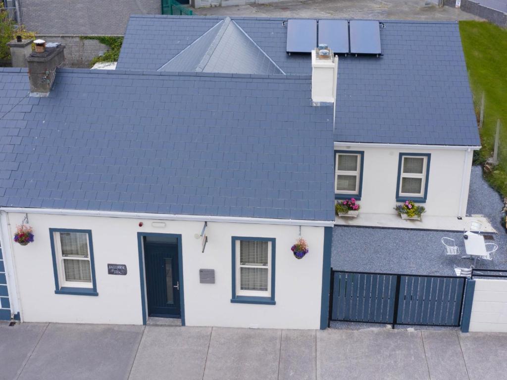 an aerial view of a white house with a black roof at Racecourse View in Listowel