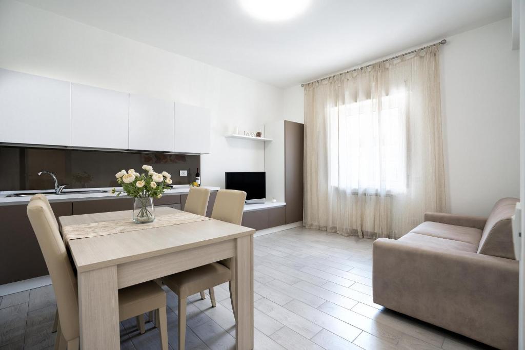 a kitchen and living room with a table and a couch at Giselle Apartments Maiori - Amalfi Coast in Maiori
