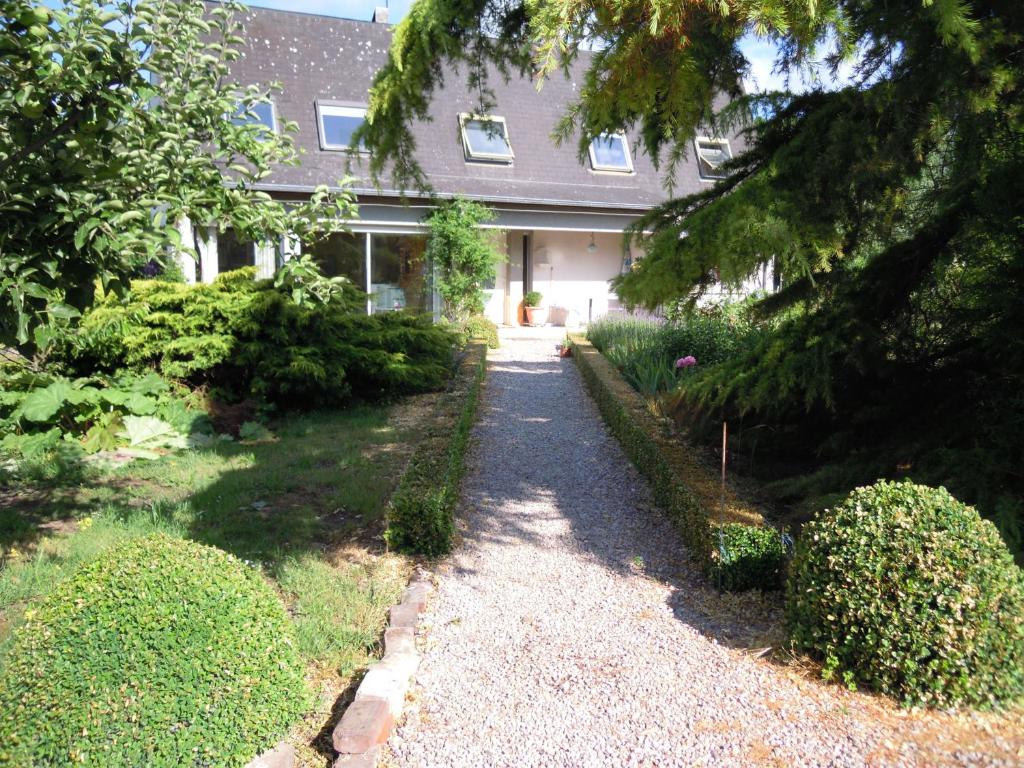 a house with a gravel path in front of it at B&B Egloff in Eaucourt-sur-Somme