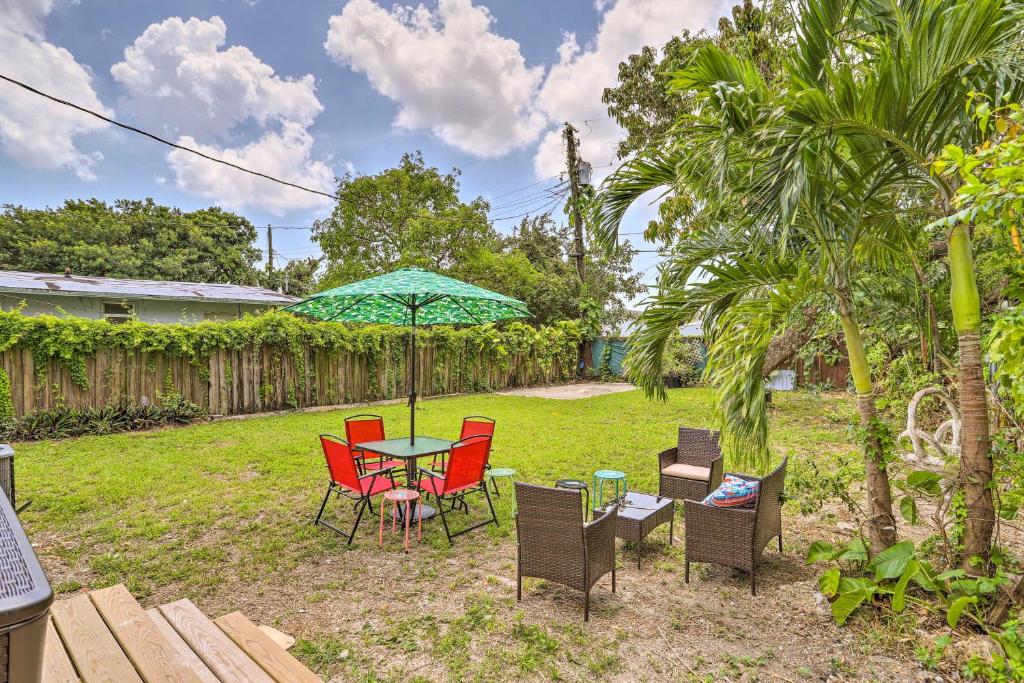 a patio with a table and chairs and an umbrella at Beautiful Miami Getaway Less Than 6 Mi to Downtown! in Miami