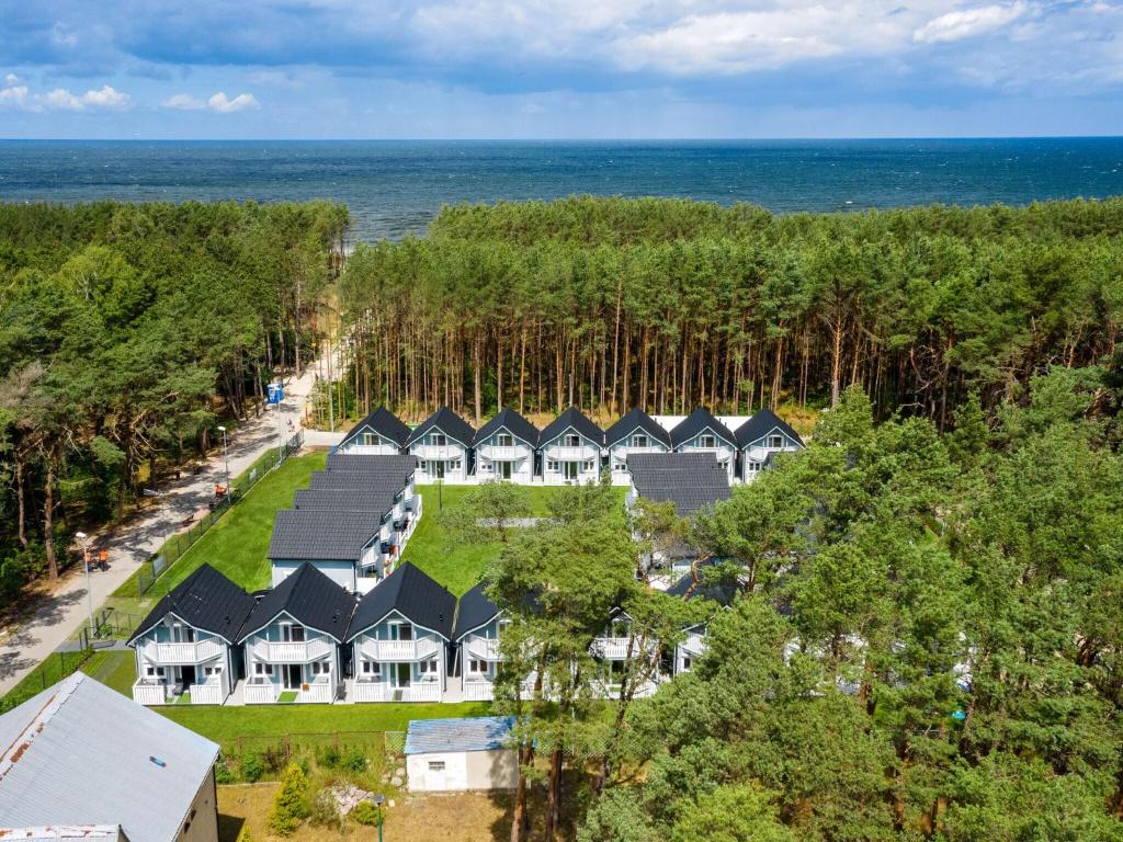 an aerial view of a house with the ocean in the background at Diune Resort at the seashore in Miedzywodzie for 7 persons in Międzywodzie