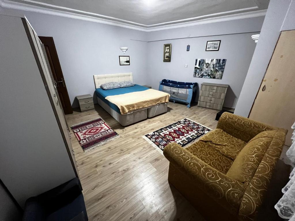 イスタンブールにあるPierreloti Suite Houseのベッドルーム1室(ベッド1台、ソファ、椅子付)