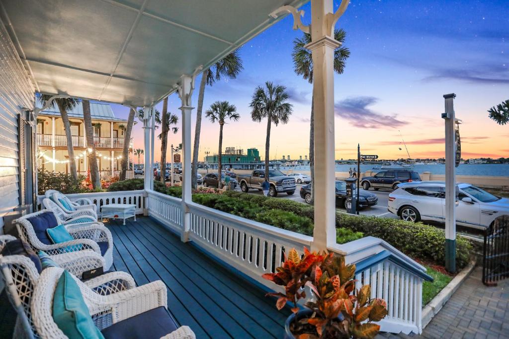 a porch with chairs and a view of a parking lot at Bayfront Westcott House Bed & Breakfast in St. Augustine