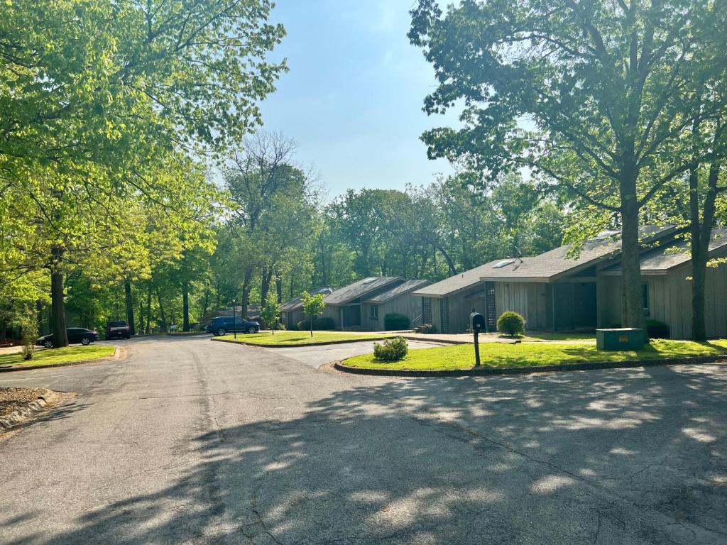 an empty street in a residential neighborhood with houses at Greens One Vacation Home 1 in Bella Vista