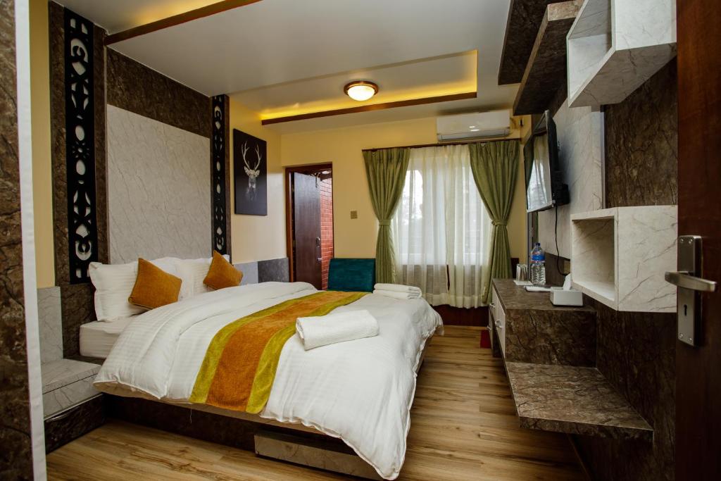 a bedroom with a large bed in a room at Gauri Shankar Hotel Nagarkot in Nagarkot