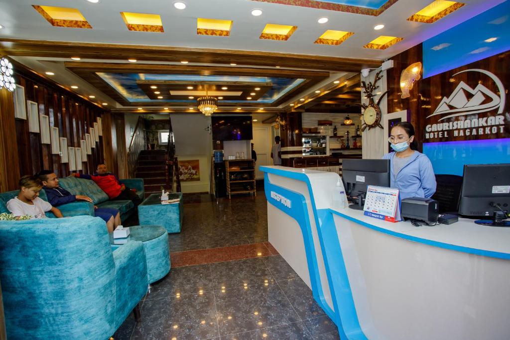 a woman wearing a mask at a counter in a store at Gauri Shankar Hotel Nagarkot in Nagarkot