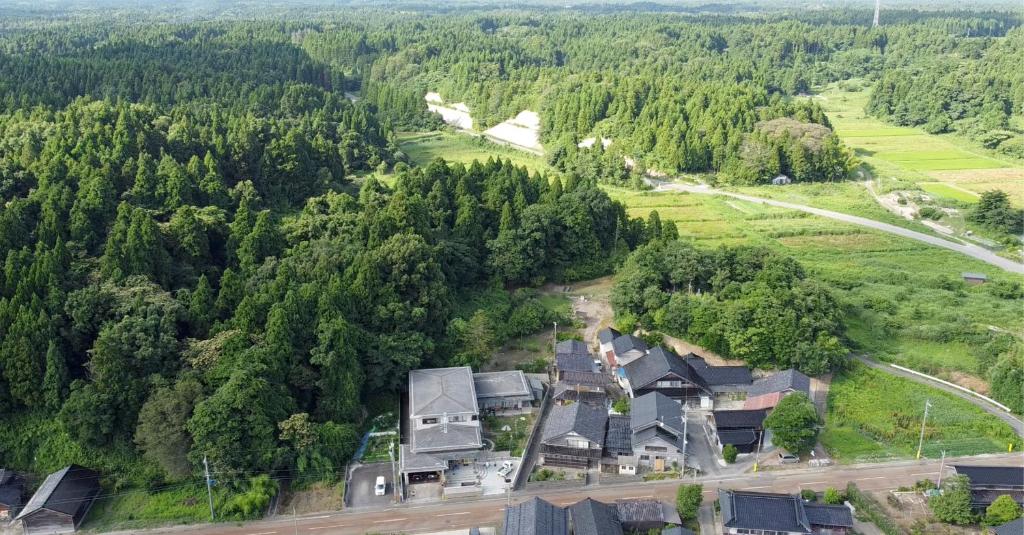 an aerial view of a house in a forest at 農家民宿　たなか in Suzu
