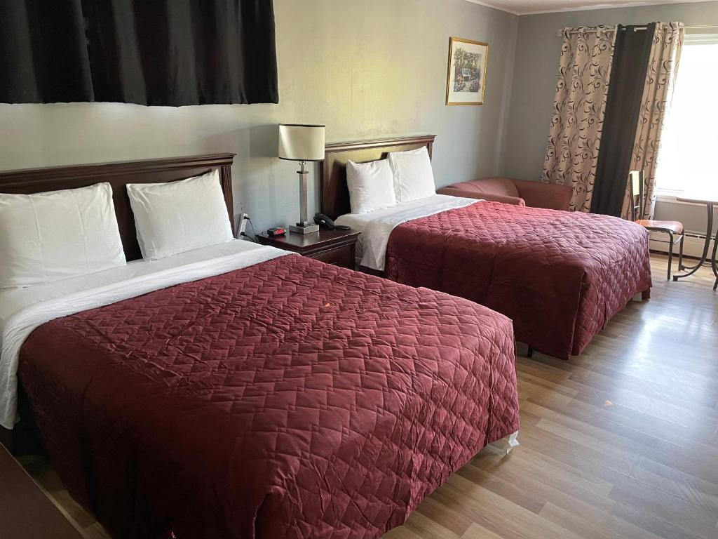 Postel nebo postele na pokoji v ubytování Nites Inn Motel