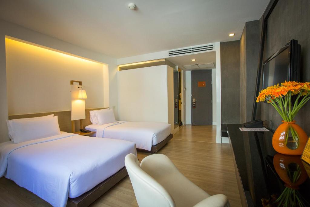 Postel nebo postele na pokoji v ubytování Trinity Silom Hotel