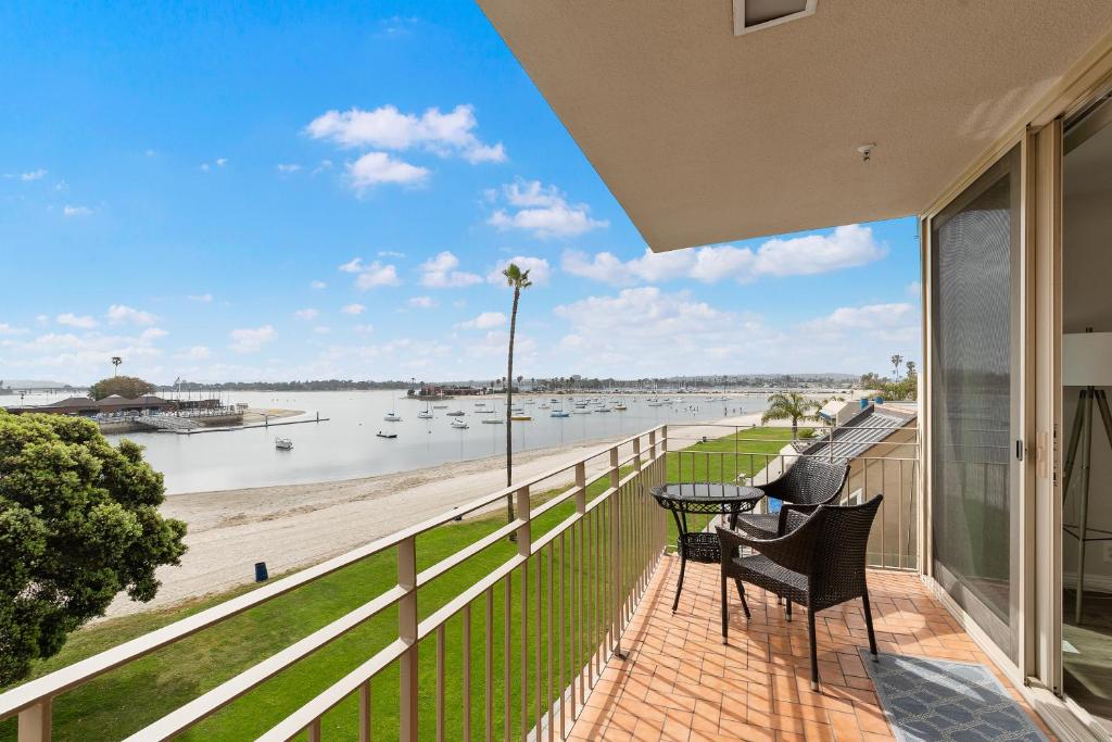 a balcony with chairs and a view of the beach at Bayside Walk Escape Unit A in San Diego