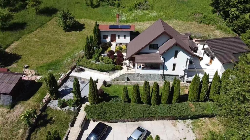 an overhead view of a house with a yard with trees at Casa dintre Brazi Hunedoara in Hunedoara