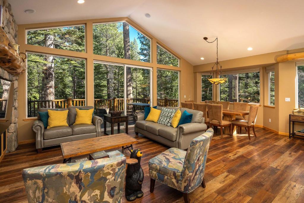 a living room with furniture and large windows at Cochise Adventures in South Lake Tahoe