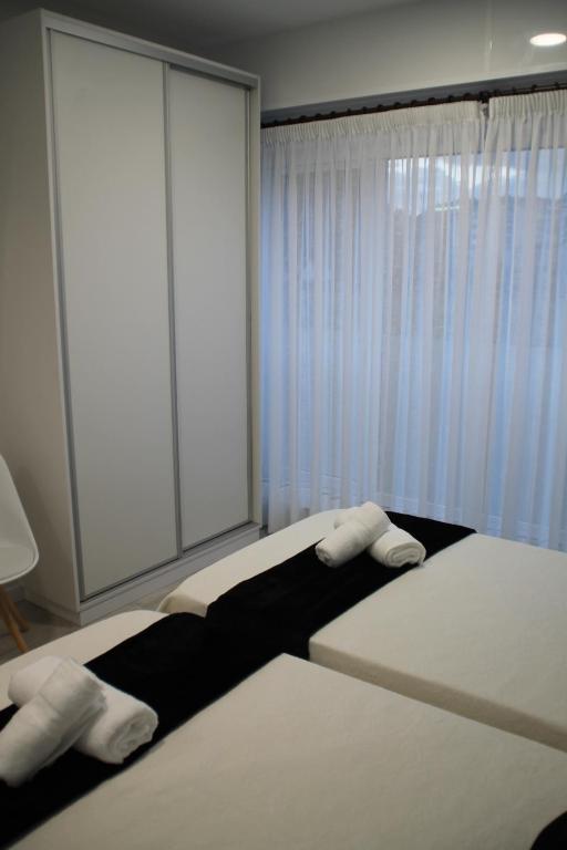 Rúm í herbergi á Baixo a Lua Rooming
