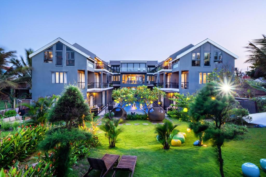 an exterior view of a house with a yard at Sea Lavie Boutique Resort & Spa in Hoi An