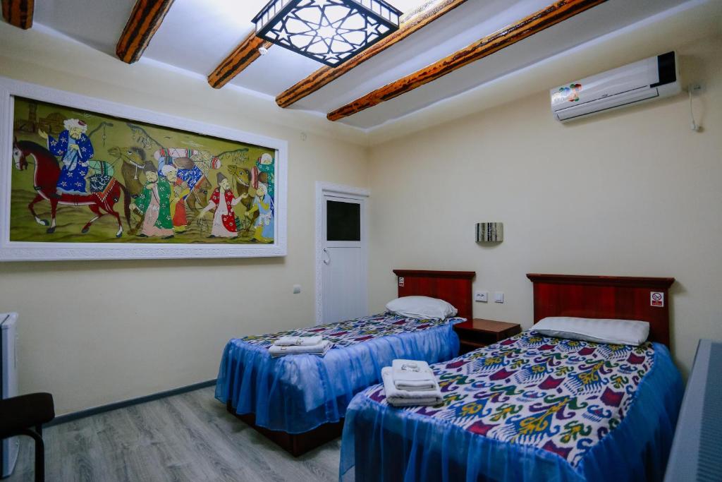 Кровать или кровати в номере Bukhara House