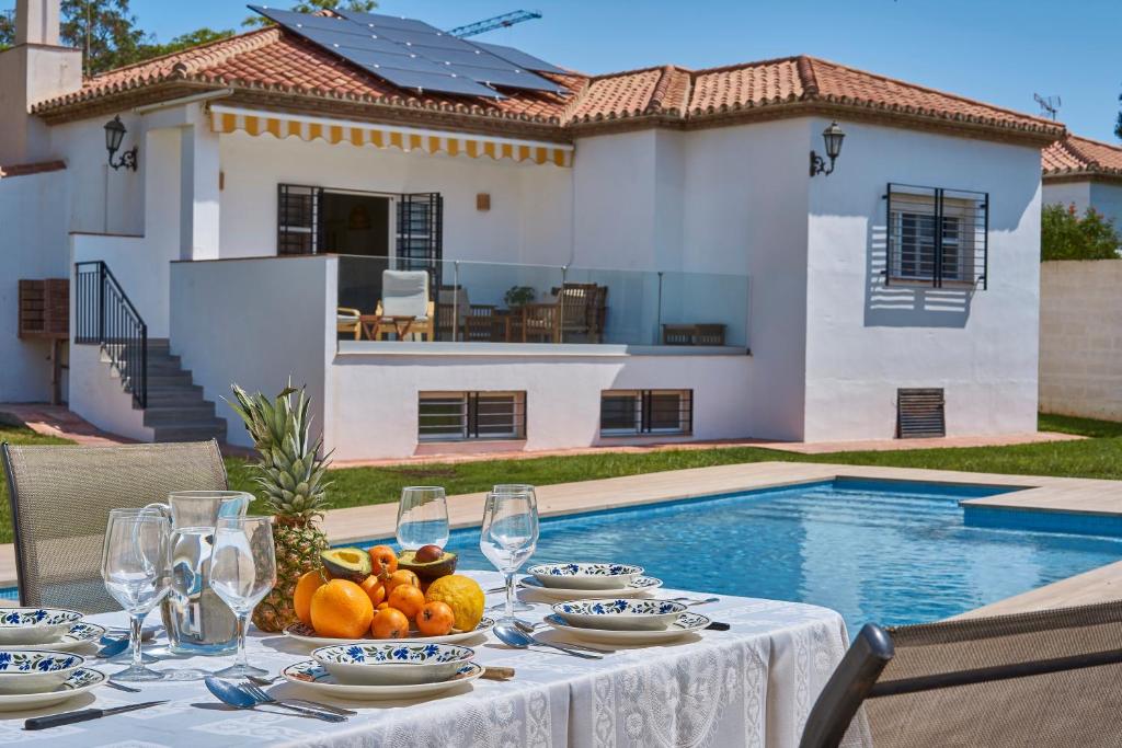 een tafel met een schaal fruit en wijnglazen bij Relax, Family, Telecommuting & Private Pool By Mellow in Vélez-Málaga