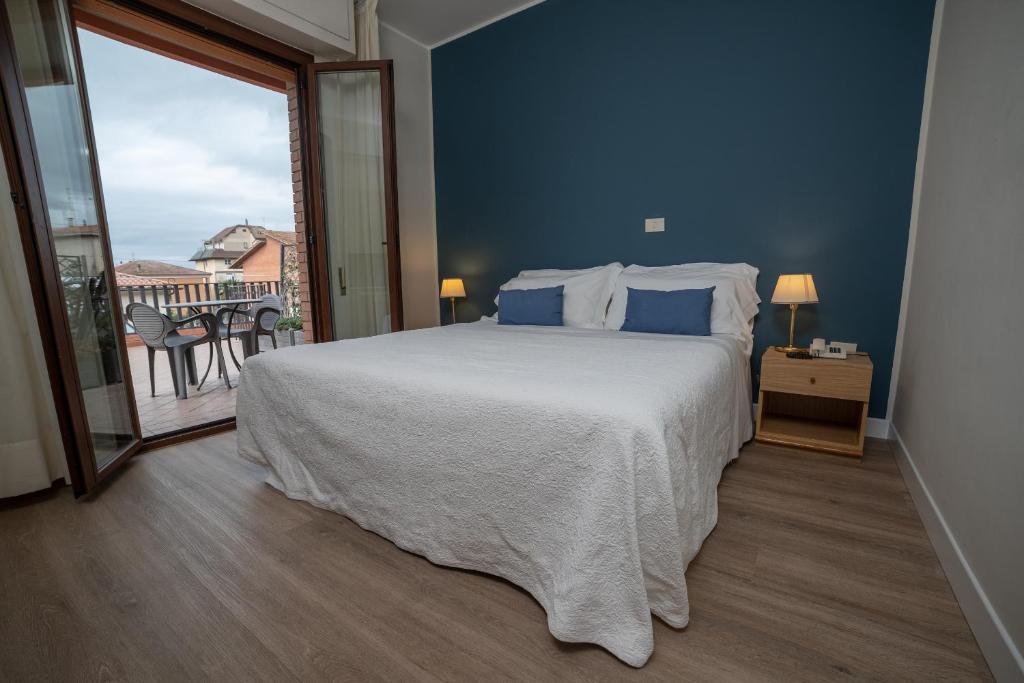 Postel nebo postele na pokoji v ubytování Hotel La Vela