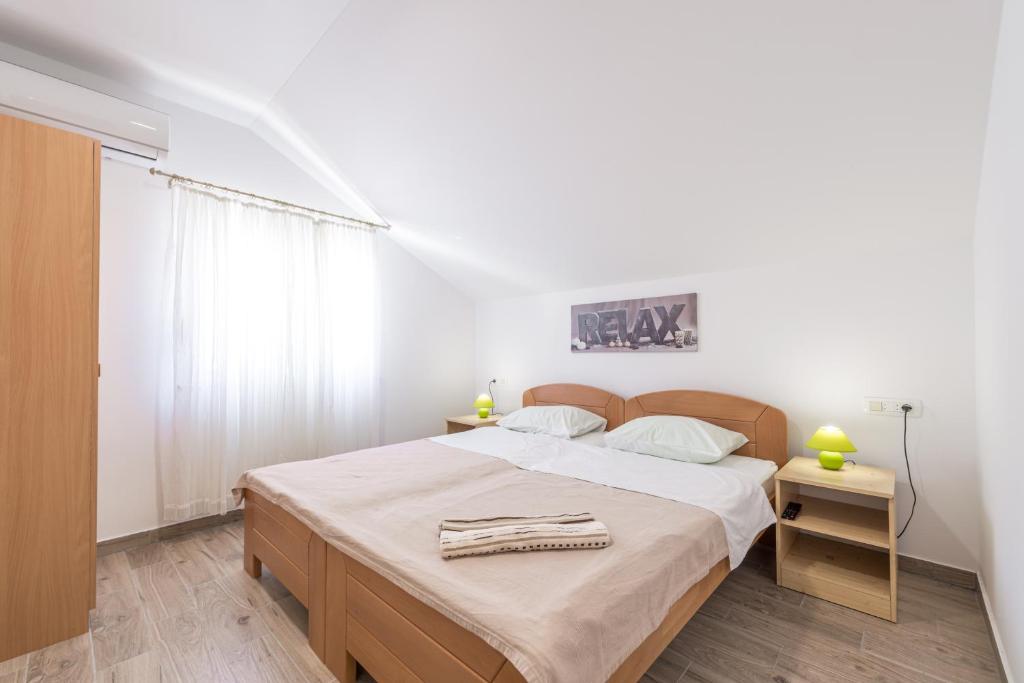Posteľ alebo postele v izbe v ubytovaní Apartments Vukelic