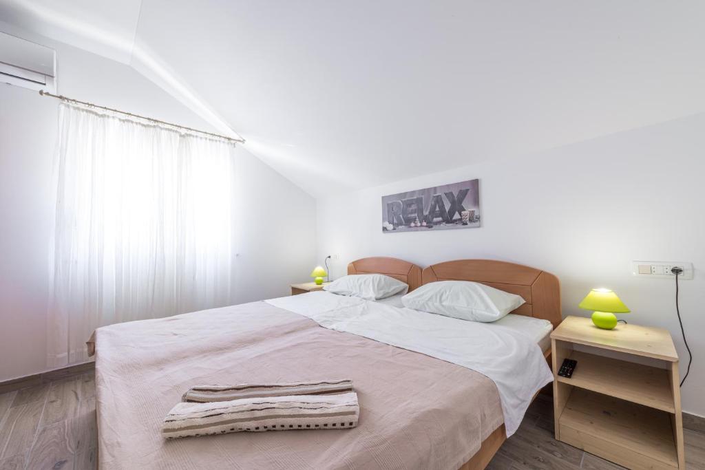 Posteľ alebo postele v izbe v ubytovaní Apartments Vukelic