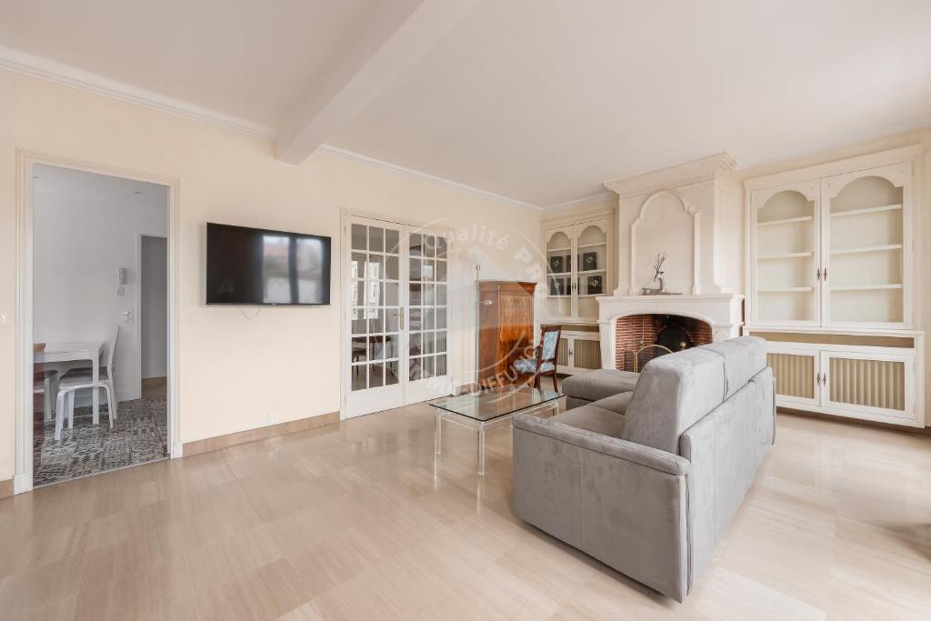 a living room with a couch and a fireplace at AS21755 - Grand P3 Vue Canal au cœur du Centre-Ville à 20m de la plage in Le Grau-du-Roi