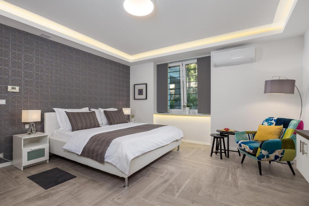 a bedroom with a bed and a desk and a chair at RIKI'S APARTMENT-ZAGREB in Zagreb