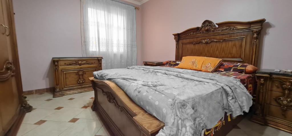 a bedroom with a large bed and wooden furniture at Comfy 2 Bedrooms Apartment in Cairo 98-5 in Cairo