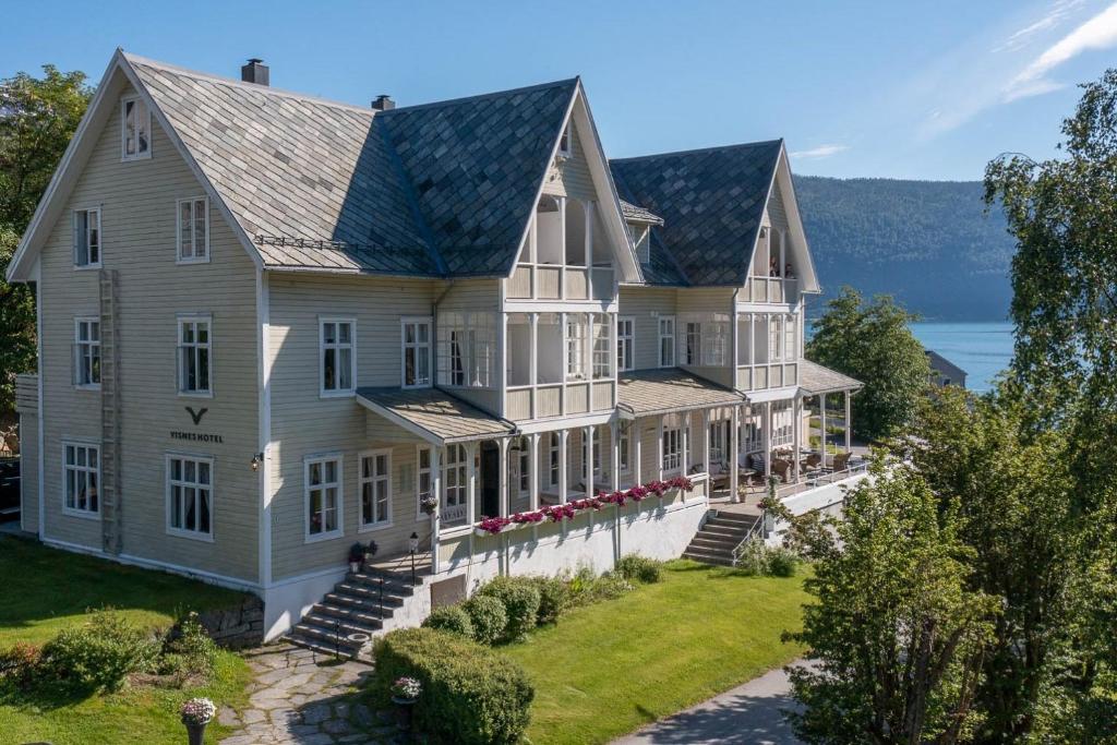 an aerial view of a large white house at Visnes Hotel Stryn in Stryn