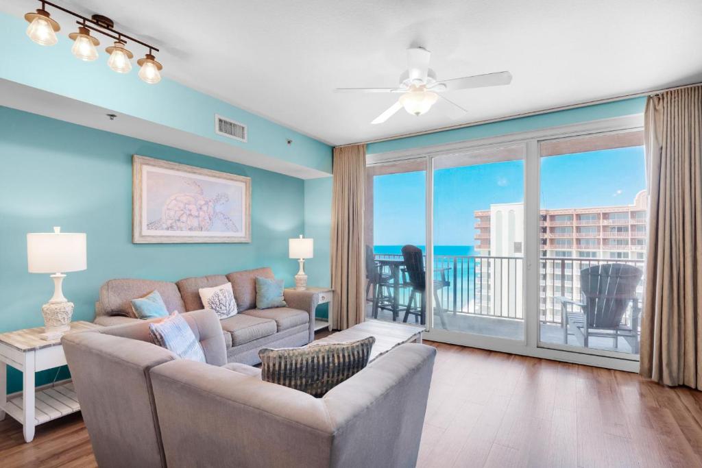 a living room with a couch and a view of the ocean at Shores of Panama 2127 in Panama City Beach