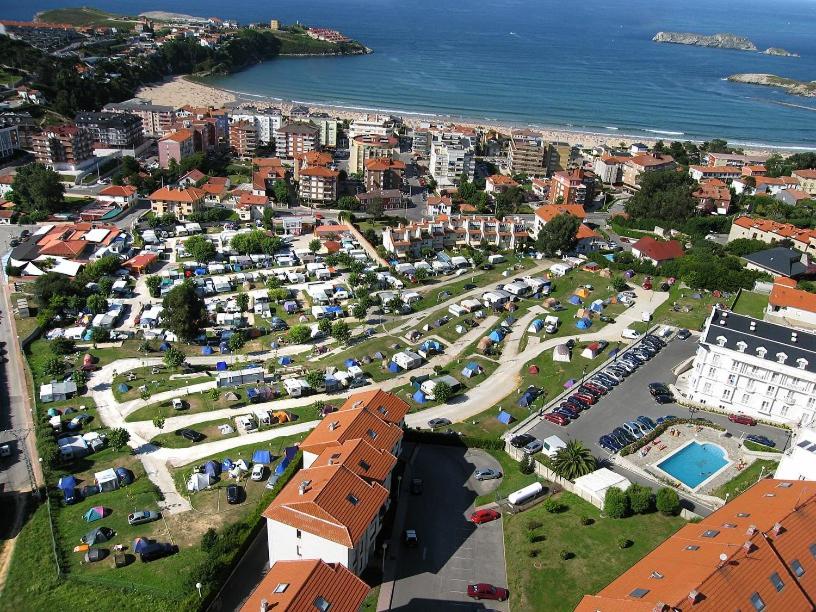 an aerial view of a city with a parking lot at CAMPING SUANCES in Suances