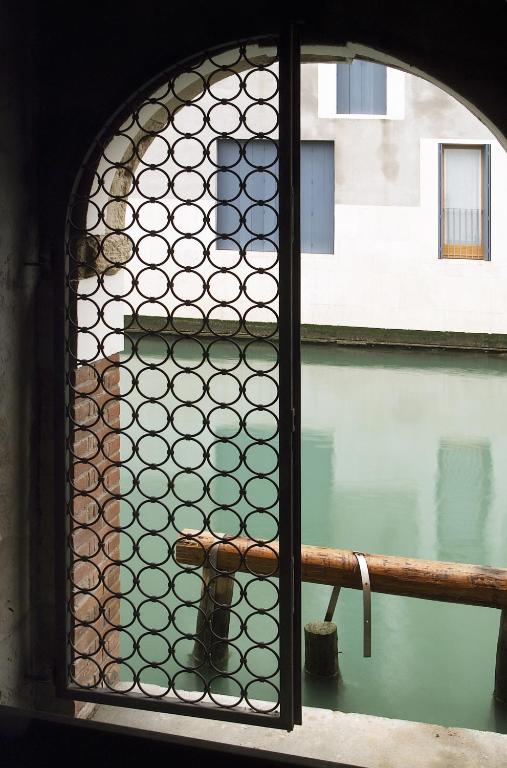 a window with a view of a body of water at Hotel Giudecca Venezia in Venice