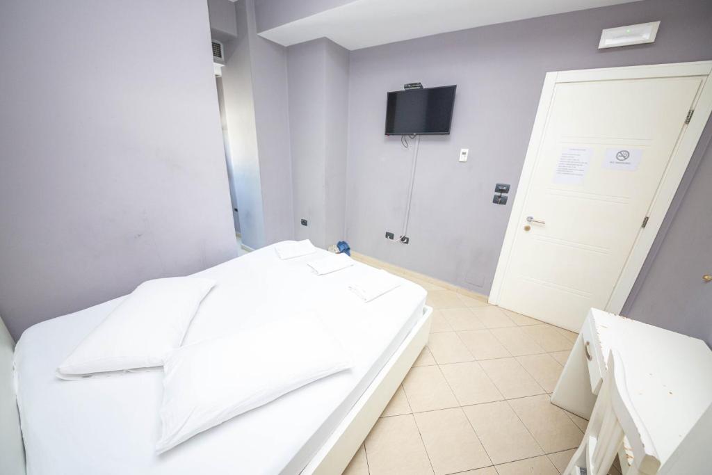 Postel nebo postele na pokoji v ubytování Hotel Tosi