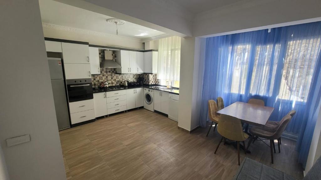 a kitchen with a table and a table and chairs at Infinity Oldtown Apartment, Located in City Center in Fethiye