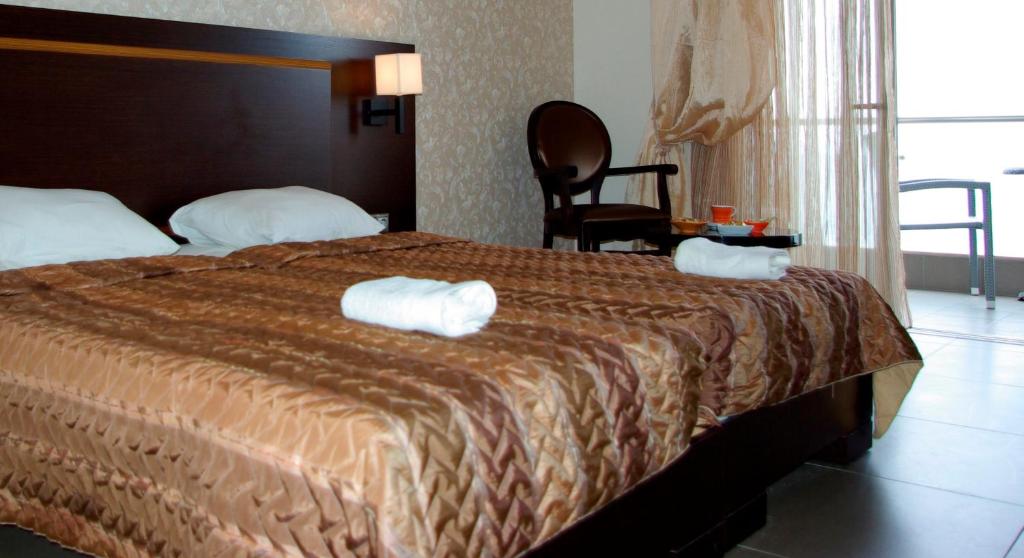 Postel nebo postele na pokoji v ubytování Dion Hotel