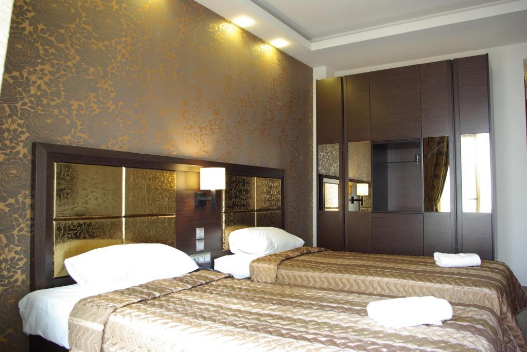 Postel nebo postele na pokoji v ubytování Dion Hotel