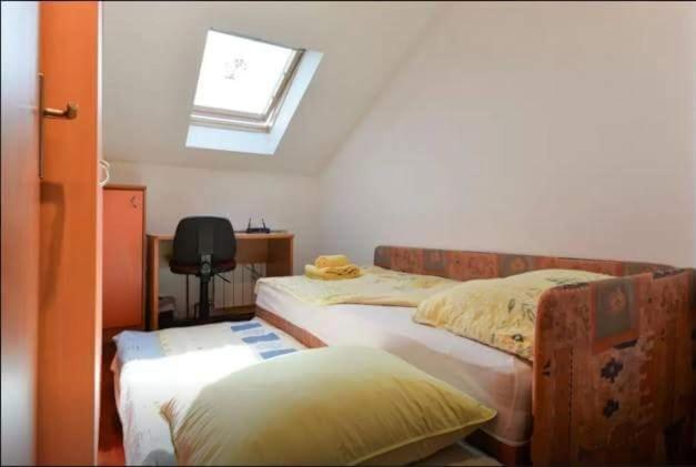 um quarto com 2 camas e uma clarabóia em NENA em Zadar